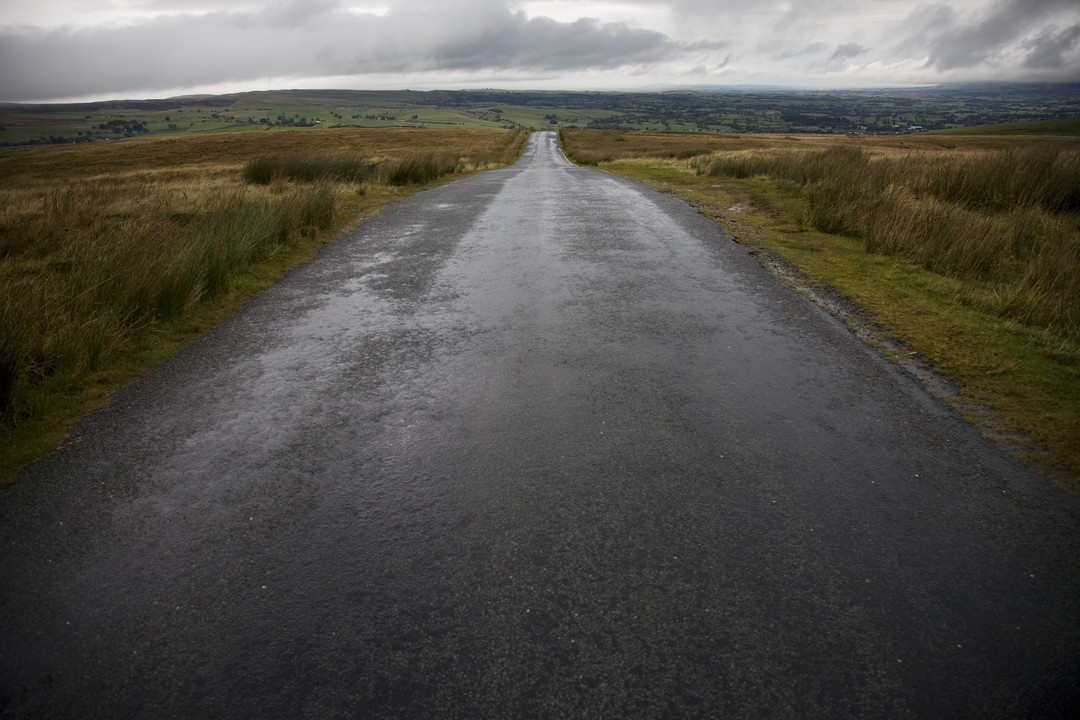 Wet road in Yorkshire Dales, Yorkshire, England